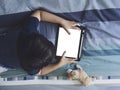 Kid wathching cartoons on tablet, Child boy lying in bed playing game on touch pad, Top view Children having activity on his own