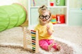 Kid weared eyeglasses playing with abacus