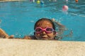 Kid wearing goggles breathing while swimming in the pool. Summer Royalty Free Stock Photo