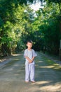 Kid on white clothing , practice walking Meditation in forest tr Royalty Free Stock Photo