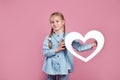 Kid with white heart on pink , St valentines day and mothers day concept