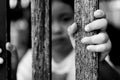 Kid with wood fence, feeling no freedom, black and white photography Royalty Free Stock Photo