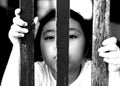 Kid with wood fence, feeling no freedom, black and white photography. Royalty Free Stock Photo