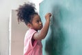 Kid write on chalk board. Back to school. Schoolchild in class. Happy kid writing green blackboard Royalty Free Stock Photo