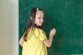 Kid write on chalk board. Back to school. Schoolchild in class. Happy kid writing green blackboard Royalty Free Stock Photo