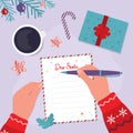 Kid writes letter to Santa Claus. Child hand with pen writes message to Father Christmas. Space for text. Gifts wish list concept