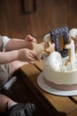 Kid& x27;s hands take gingerbread from the birthday cake