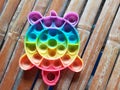 Kid's Rainbow "Pop It" Toy on Old Bamboo Surface Royalty Free Stock Photo