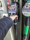 Customer replaces a diesel fuel pump nozzle, at the Tesco petrol station,Kidderminster