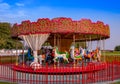 Kiddie Carousel ride for kids in the park during sunset Royalty Free Stock Photo