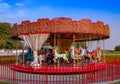 Kiddie Carousel ride for kids in the park during sunset