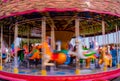 Kiddie Carousel ride for kids in the park during sunset Royalty Free Stock Photo