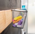 Kiddies play chalks stowed in a mesh basket