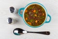 Kidney bean soup in blue bowl, salt, pepper and spoon