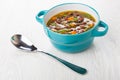 Kidney bean soup in blue bowl and spoon on table Royalty Free Stock Photo