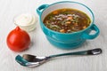 Kidney bean soup, spoon, tomato, bowl with mayonnaise on table Royalty Free Stock Photo