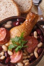 Kidney beans with chicken and grilled sausages vertical top view Royalty Free Stock Photo