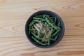 Kidney beans with grind sesame dressing in the bowl isolted on the wooden table Royalty Free Stock Photo