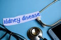 Kidney disease inscription with the view of stethoscope, eyeglasses and smartphone on the blue background. Royalty Free Stock Photo
