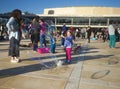 Kids and adults blow soap bubbles in the street