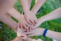 Close up of a kids and adults hands together in circle laying one on another Royalty Free Stock Photo