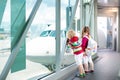 Kids travel and fly. Child at airplane in airport Royalty Free Stock Photo