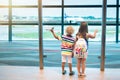 Kids travel and fly. Child at airplane in airport Royalty Free Stock Photo