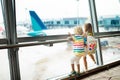 Kids travel and fly. Child at airplane in airport Royalty Free Stock Photo