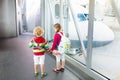 Kids travel and fly. Child at airplane in airport Royalty Free Stock Photo