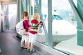 Kids travel and fly. Child at airplane in airport Royalty Free Stock Photo