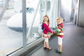 Kids travel and fly. Child at airplane in airport Royalty Free Stock Photo