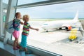 Kids travel and fly. Child at airplane in airport Royalty Free Stock Photo