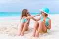 Kids applying sun cream to each other on the beach. The concept of protection from ultraviolet radiation