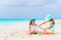 Kids applying sun cream to each other on the beach. The concept of protection from ultraviolet radiation