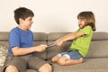 Kids arguing for playing with a digital tablet