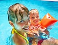 Kids with armbands in swimming pool. Royalty Free Stock Photo