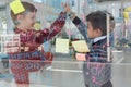 Kids as business executives giving high five to each other near whiteboard Royalty Free Stock Photo