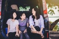 Kids and Aunty relax on car