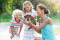 Kids with baby pig animal. Children at farm or zoo Royalty Free Stock Photo