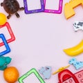 Kids background with colorful toys, frame, on pink backround. Copy space, flat lay, top view Royalty Free Stock Photo