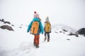 kids with backpacks on snowy mountain trek