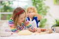 Kids baking. Children cooking in white kitchen Royalty Free Stock Photo