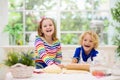 Kids baking. Children cooking in white kitchen Royalty Free Stock Photo