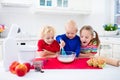 Kids baking a pie in white kitchen Royalty Free Stock Photo