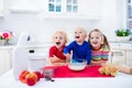 Kids baking a pie in white kitchen Royalty Free Stock Photo