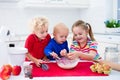 Kids baking a pie in white kitchen Royalty Free Stock Photo