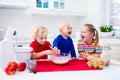 Kids baking a pie in white kitchen Royalty Free Stock Photo