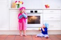 Kids baking in a white kitchen