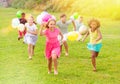 Kids with balloons running through field