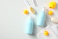 Kids bath accessories. Baby bathing concept. Shampoo and shower gel bottles with yellow ducks and towel on white table. Flat lay, Royalty Free Stock Photo
